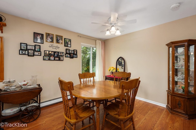 1056 N Mill St Unit 305, Naperville, IL 60563 - dining area with a baseboard heating unit, light wood finished floors, and a ceiling fan