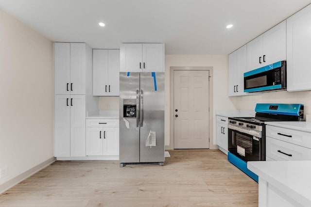 519 Everette Ave, Romeoville, IL 60446 - kitchen featuring stainless steel appliances, light countertops, light wood-style floors, white cabinetry, and recessed lighting