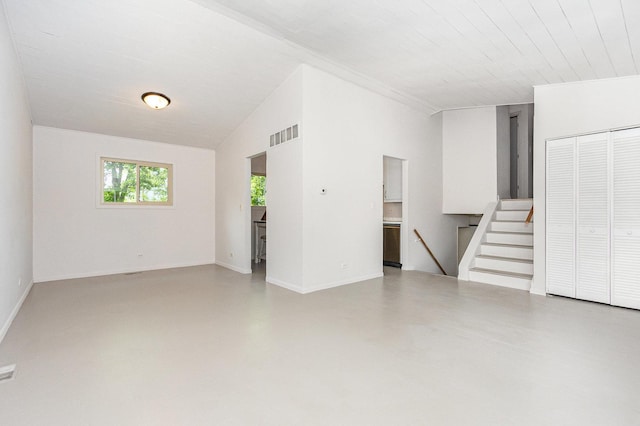 3020 Timber Hill Ct, Aurora, IL 60504 - empty room featuring concrete flooring, lofted ceiling, and stairs