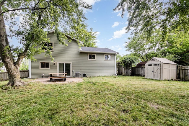 3020 Timber Hill Ct, Aurora, IL 60504 - rear view of house featuring a fenced backyard, a storage unit, and a patio area