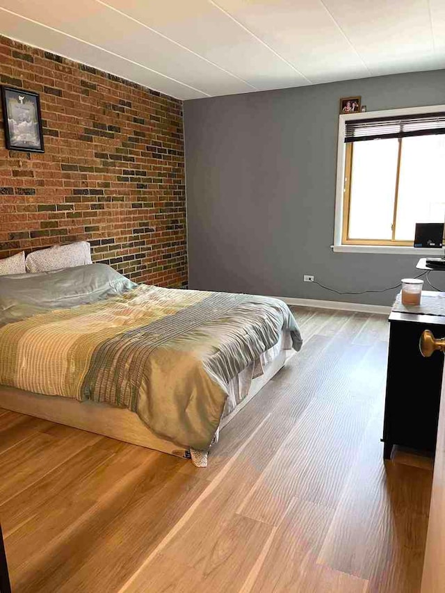 900 S River Rd Unit 3A, Des Plaines, IL 60016 - bedroom featuring brick wall and wood finished floors