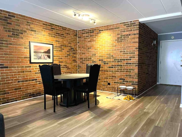 900 S River Rd Unit 3A, Des Plaines, IL 60016 - dining room featuring wood finished floors and brick wall