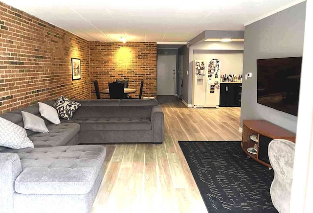 900 S River Rd Unit 3A, Des Plaines, IL 60016 - living room featuring wood finished floors and brick wall