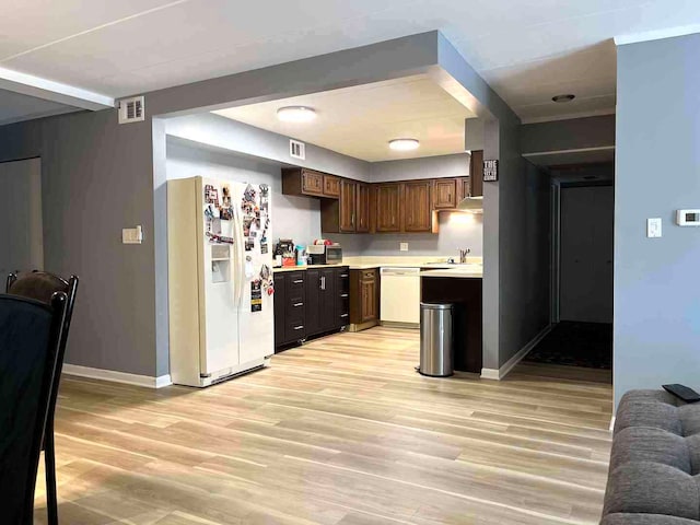 900 S River Rd Unit 3A, Des Plaines, IL 60016 - kitchen with white appliances, light countertops, light wood-style flooring, and dark brown cabinets