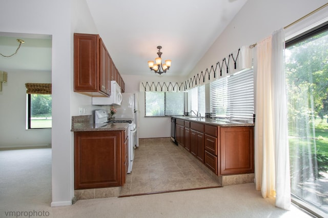 771 E Devon Ave, Roselle, IL 60172 - kitchen with white appliances, light carpet, a chandelier, vaulted ceiling, and healthy amount of natural light