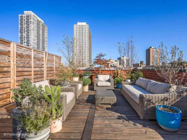 1942 N Sedgwick St Unit Ph, Chicago, IL 60614 - wooden terrace with an outdoor hangout area, a fenced backyard, and a view of city