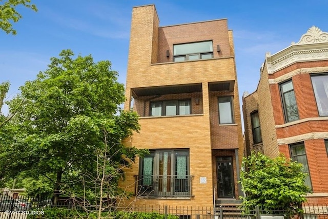 6640 S Maryland Ave Unit 2, Chicago, IL 60637 - view of front of property with brick siding, a fenced front yard, and a chimney