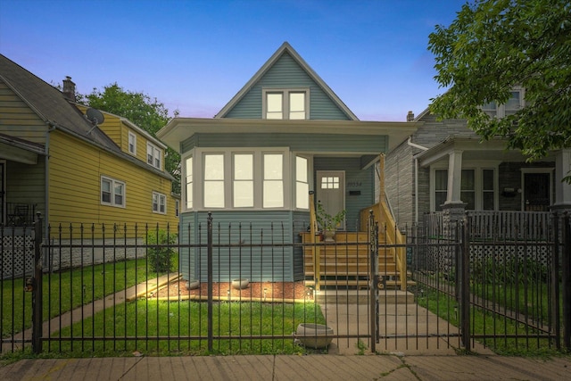 10554 S State St, Chicago, IL 60628 - view of front of property featuring covered porch, a fenced front yard, and a gate
