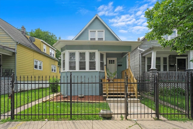 10554 S State St, Chicago, IL 60628 - view of front of property with a fenced front yard, a gate, and a porch