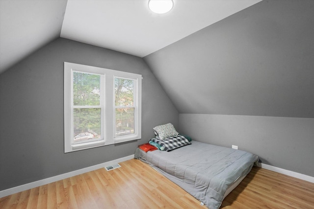 10554 S State St, Chicago, IL 60628 - bedroom with vaulted ceiling and wood finished floors