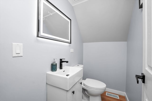 10554 S State St, Chicago, IL 60628 - half bathroom featuring vanity, lofted ceiling, and wood finished floors