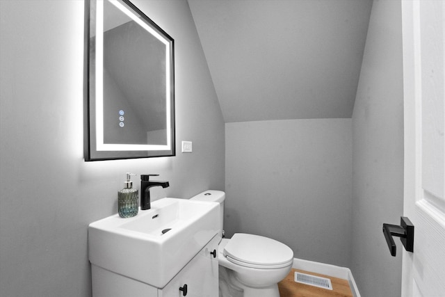 10554 S State St, Chicago, IL 60628 - half bath featuring vanity, lofted ceiling, and wood finished floors