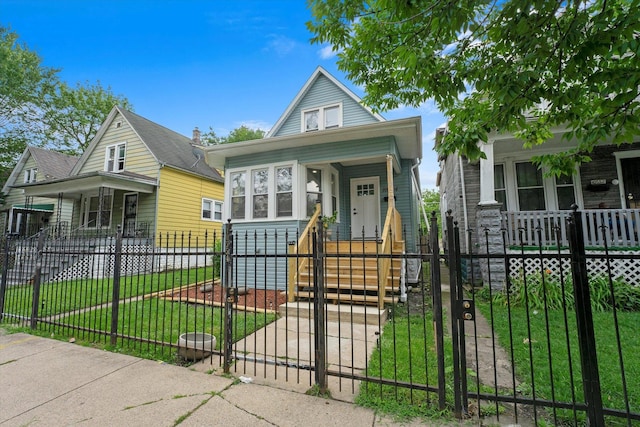 10554 S State St, Chicago, IL 60628 - shotgun-style home with covered porch, a gate, and a fenced front yard
