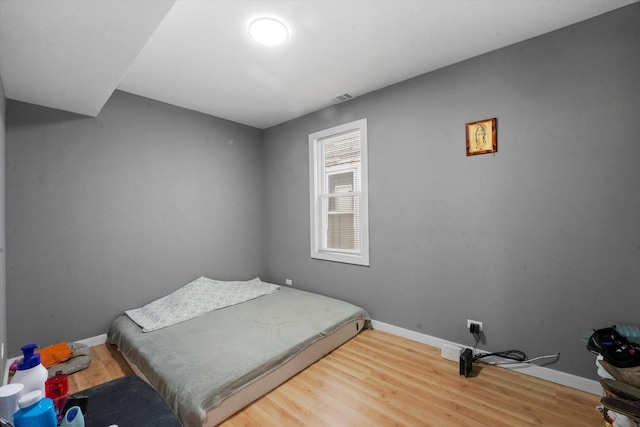 10554 S State St, Chicago, IL 60628 - bedroom featuring baseboards and wood finished floors