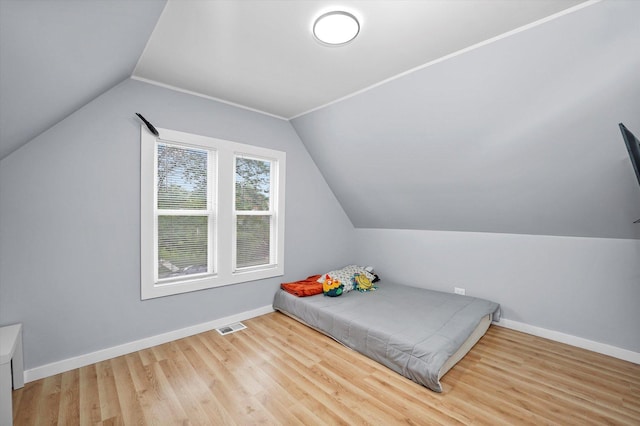 10554 S State St, Chicago, IL 60628 - bedroom with lofted ceiling and wood finished floors