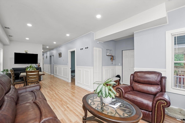 10554 S State St, Chicago, IL 60628 - living area featuring a wainscoted wall, light wood-style flooring, a decorative wall, and recessed lighting