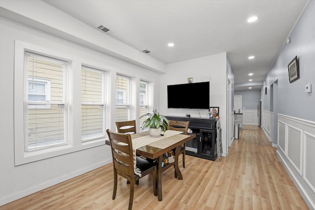 10554 S State St, Chicago, IL 60628 - dining space with light wood finished floors, wainscoting, recessed lighting, and a decorative wall