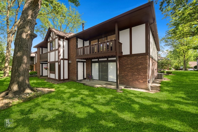 11210 Sycamore Ln Unit 61D, Palos Hills, IL 60465 - back of house with brick siding, a yard, and a balcony