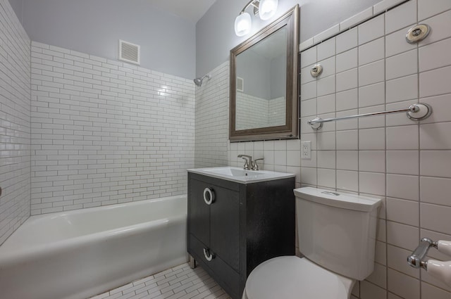 4018 N Maplewood Ave, Chicago, IL 60618 - bathroom featuring tile walls, vanity, and shower / bath combination