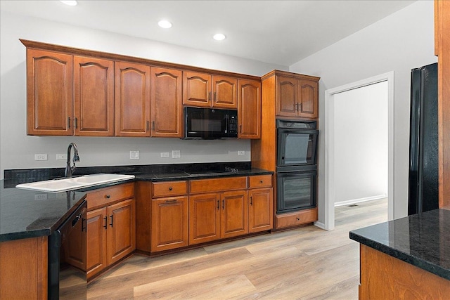 21649 Kent Ct, Frankfort, IL 60423 - kitchen featuring black appliances, light wood-style flooring, brown cabinetry, recessed lighting, and dark stone countertops