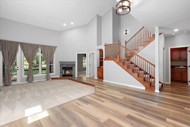 21649 Kent Ct, Frankfort, IL 60423 - unfurnished living room featuring wood finished floors, stairs, plenty of natural light, a towering ceiling, and recessed lighting