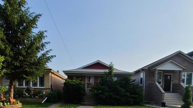 7528 W Winnemac Ave, Harwood Heights, IL 60706 - bungalow-style house featuring brick siding and a front lawn