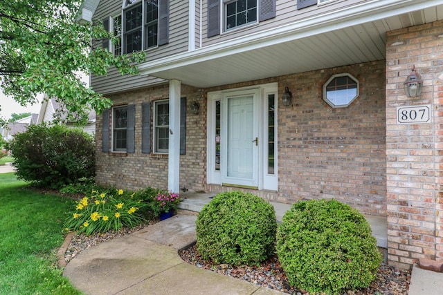 807 Eddy Rd, Bloomington, IL 61704 - view of exterior entry featuring brick siding and a porch