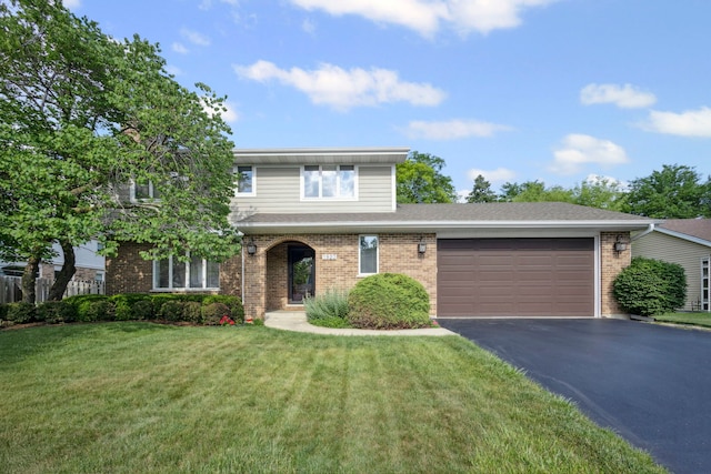 1923 N Carlyle Pl, Arlington Heights, IL 60004 - traditional-style home featuring asphalt driveway, an attached garage, brick siding, and a front lawn