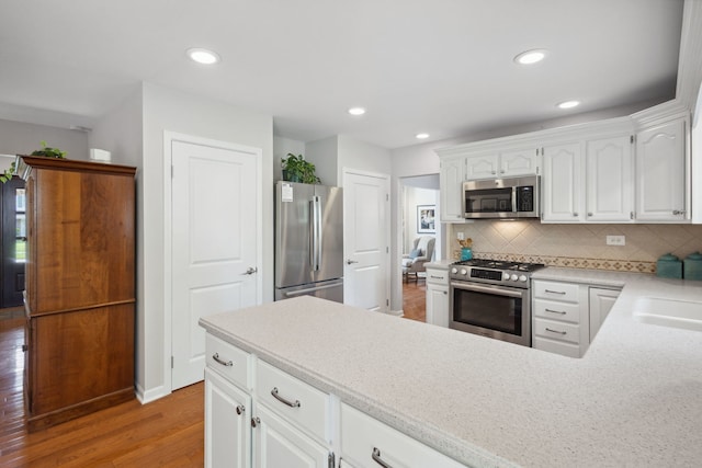 1923 N Carlyle Pl, Arlington Heights, IL 60004 - kitchen featuring appliances with stainless steel finishes, light wood-style floors, tasteful backsplash, white cabinets, and recessed lighting