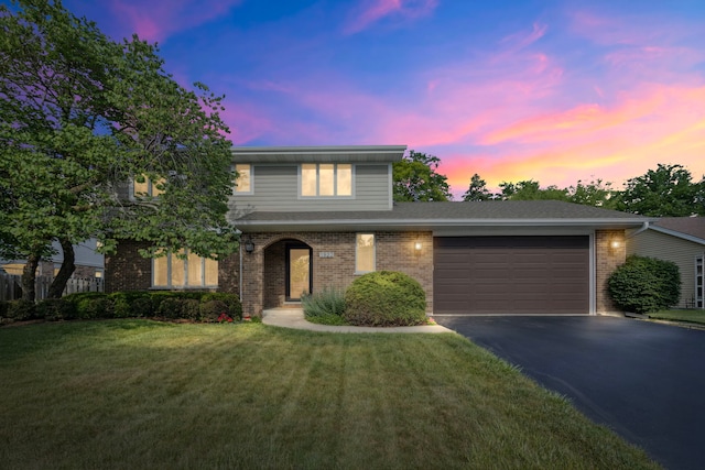 1923 N Carlyle Pl, Arlington Heights, IL 60004 - traditional-style house with asphalt driveway, a garage, a front yard, and brick siding