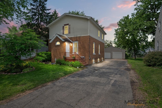 1321 N 14th St, Dekalb, IL 60115 - view of front facade with an outbuilding, brick siding, a garage, and a front lawn