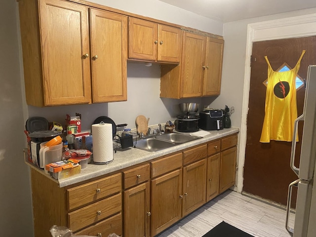 1420 Wentworth Ave, Calumet City, IL 60409 - kitchen featuring freestanding refrigerator, light countertops, and brown cabinets