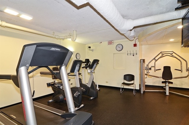 1560 N Sandburg Ter Unit 915, Chicago, IL 60610 - gym with a textured ceiling and baseboards