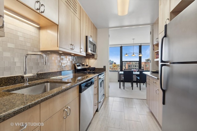 1560 N Sandburg Ter Unit 915, Chicago, IL 60610 - kitchen with appliances with stainless steel finishes, light brown cabinetry, dark stone countertops, and backsplash