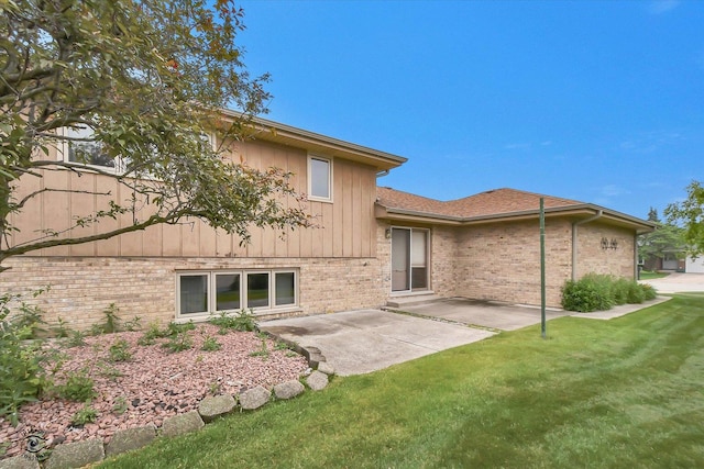 8820 Meadowview Dr, Orland Hills, IL 60487 - back of property with brick siding, a patio area, a lawn, a shingled roof, and board and batten siding