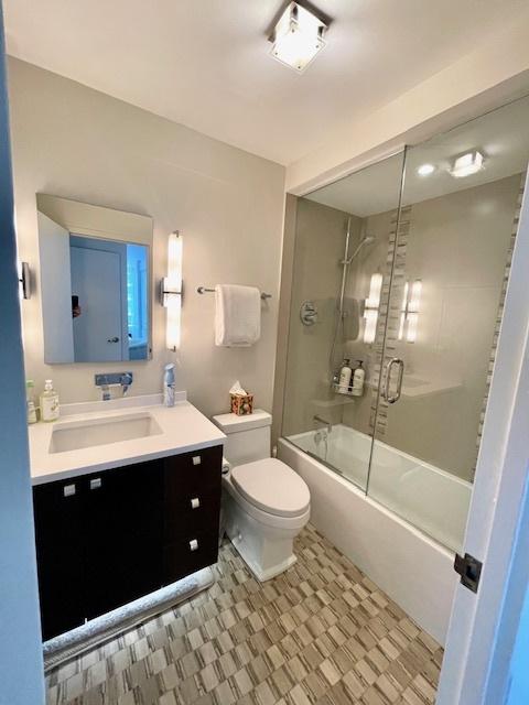 2800 N Lake Shore Dr Unit 1417, Chicago, IL 60657 - bathroom featuring vanity, enclosed tub / shower combo, and tile patterned floors