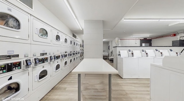 2800 N Lake Shore Dr Unit 1417, Chicago, IL 60657 - community laundry with stacked washer and clothes dryer, independent washer and dryer, and light wood finished floors