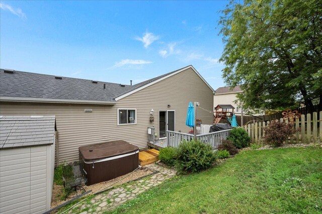 4756 Flanders Ct, Plainfield, IL 60586 - rear view of property with a hot tub, roof with shingles, and a deck