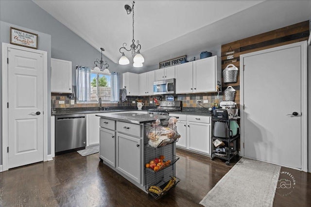 4756 Flanders Ct, Plainfield, IL 60586 - kitchen featuring stainless steel appliances, lofted ceiling, backsplash, dark countertops, and white cabinets