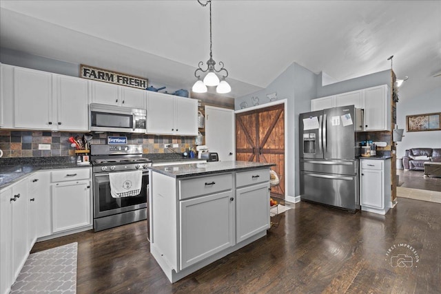 4756 Flanders Ct, Plainfield, IL 60586 - kitchen featuring stainless steel appliances, vaulted ceiling, backsplash, white cabinets, and a center island