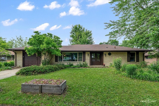2290 Copley St, Aurora, IL 60506 - single story home with an attached garage, driveway, a front yard, and brick siding