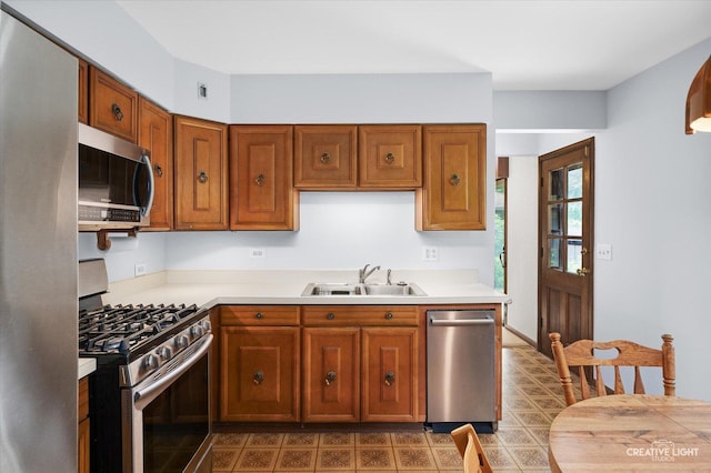 2290 Copley St, Aurora, IL 60506 - kitchen with stainless steel appliances, brown cabinetry, and light countertops
