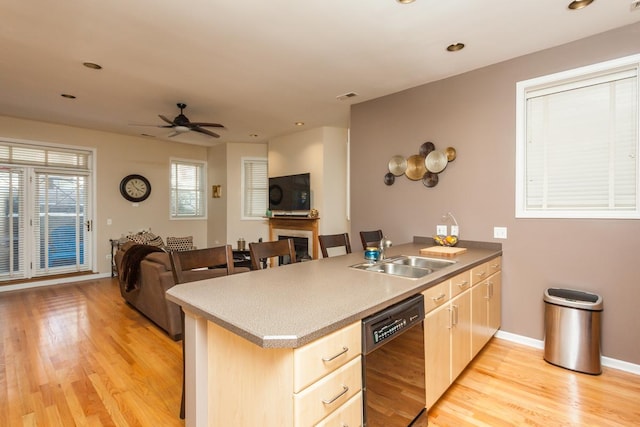 4124 N Kenmore Ave Unit Gs, Chicago, IL 60613 - kitchen with black dishwasher, light wood finished floors, open floor plan, a peninsula, and a ceiling fan