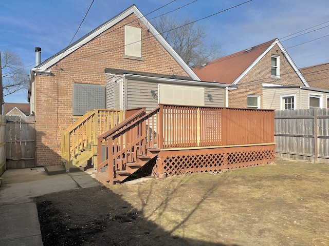 1937 N Normandy Ave, Chicago, IL 60607 - back of property with brick siding, a wooden deck, and a fenced backyard