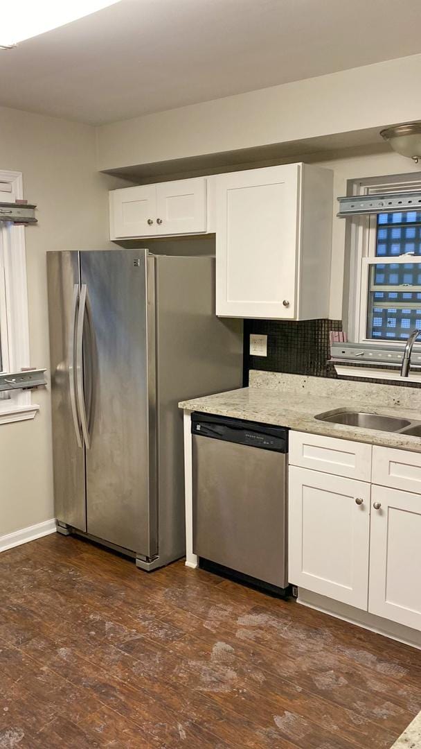 1937 N Normandy Ave, Chicago, IL 60607 - kitchen with appliances with stainless steel finishes, white cabinets, dark wood-style flooring, light stone counters, and tasteful backsplash