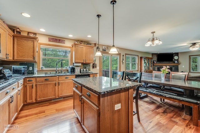 2800 Arbor Ln, Oswego, IL 60543 - kitchen featuring healthy amount of natural light, light wood finished floors, a chandelier, a breakfast bar area, and recessed lighting