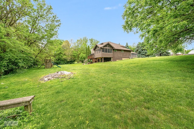 2800 Arbor Ln, Oswego, IL 60543 - view of green lawn with a playground and a wooden deck