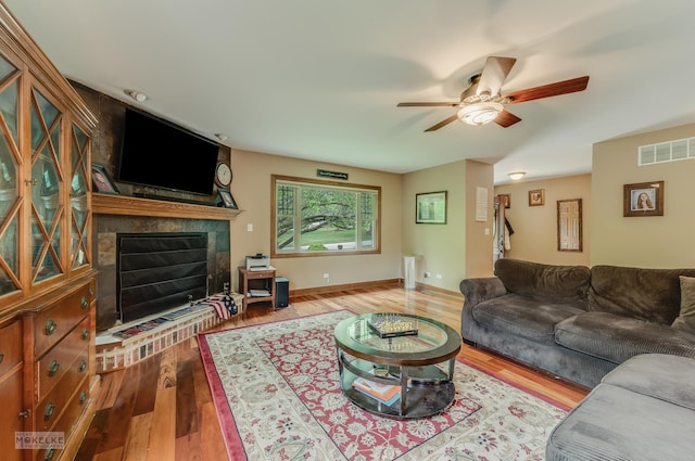 2800 Arbor Ln, Oswego, IL 60543 - living area with a large fireplace, a ceiling fan, and wood finished floors