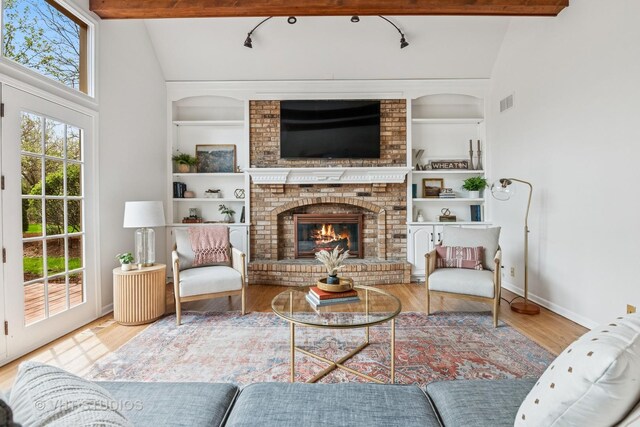 1181 Midwest Ln, Wheaton, IL 60189 - living area with built in shelves, wood finished floors, and a brick fireplace