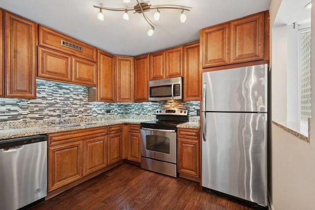 200 N Dearborn St Unit 2402, Chicago, IL 60601 - kitchen with appliances with stainless steel finishes, backsplash, brown cabinets, and dark wood finished floors